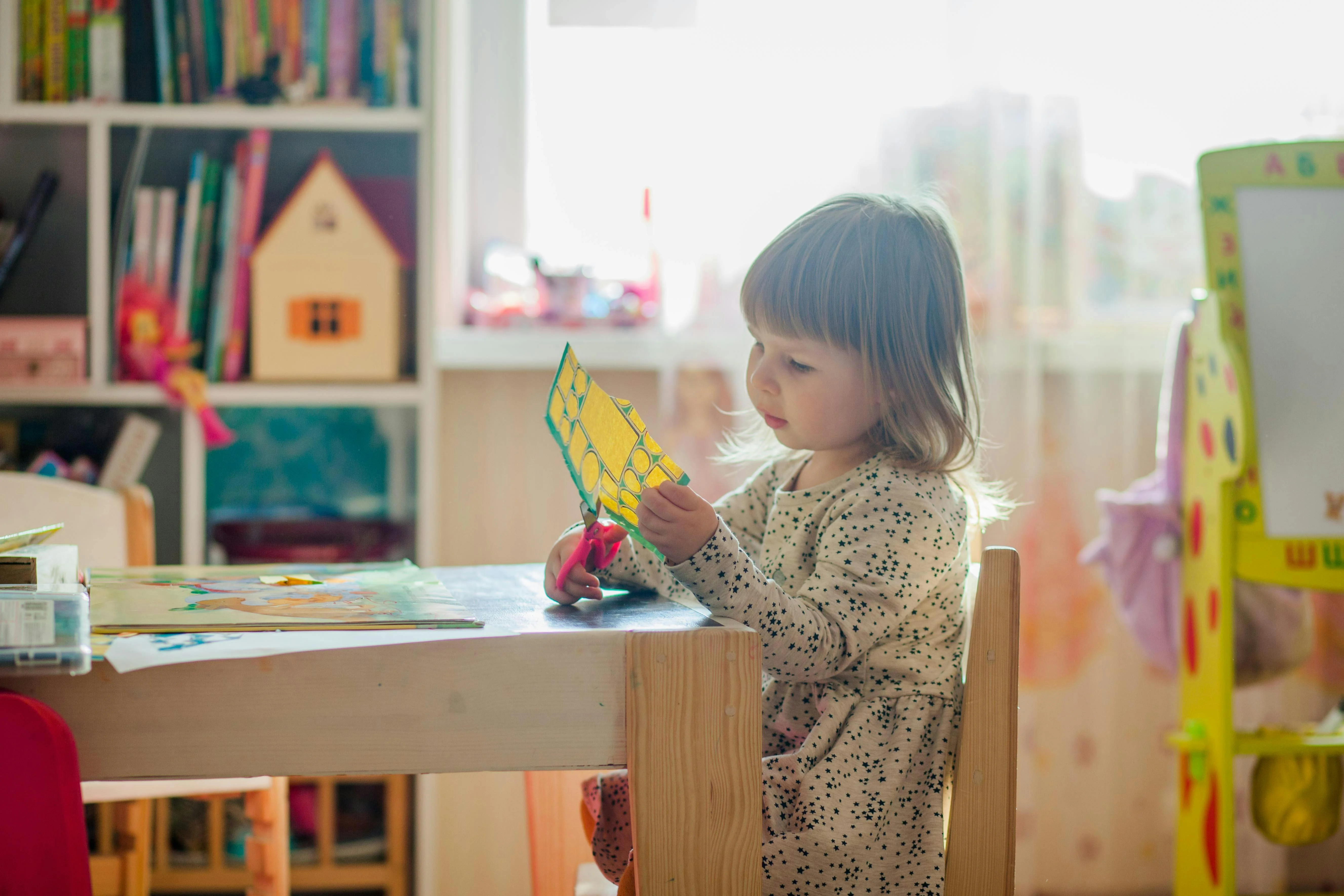 Caregiver with children in a learning space